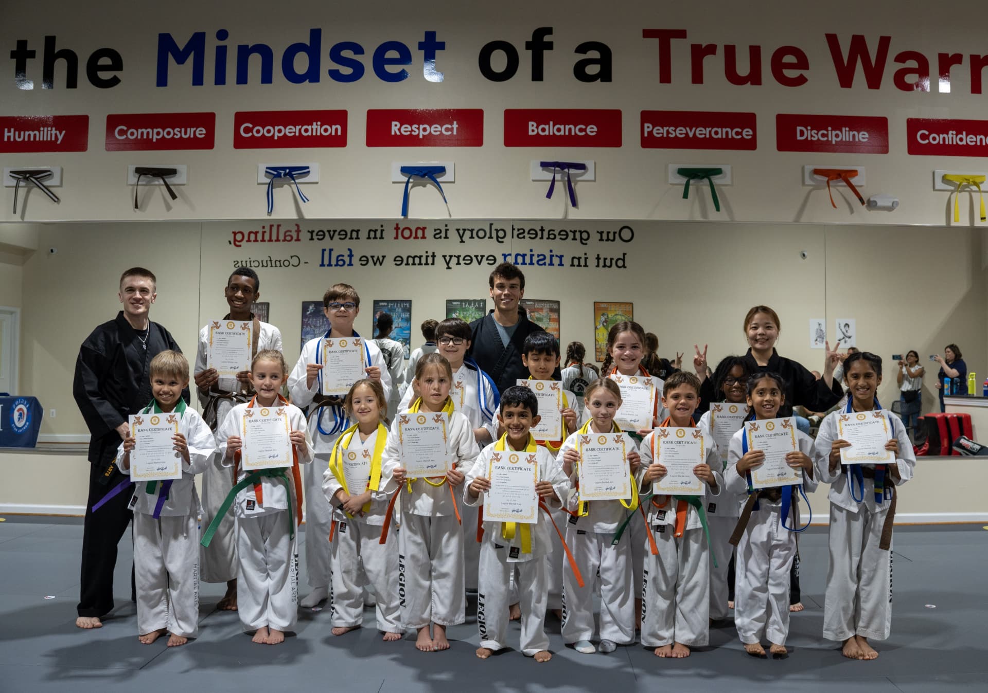 Juniors students holding up their rank certificates after testing