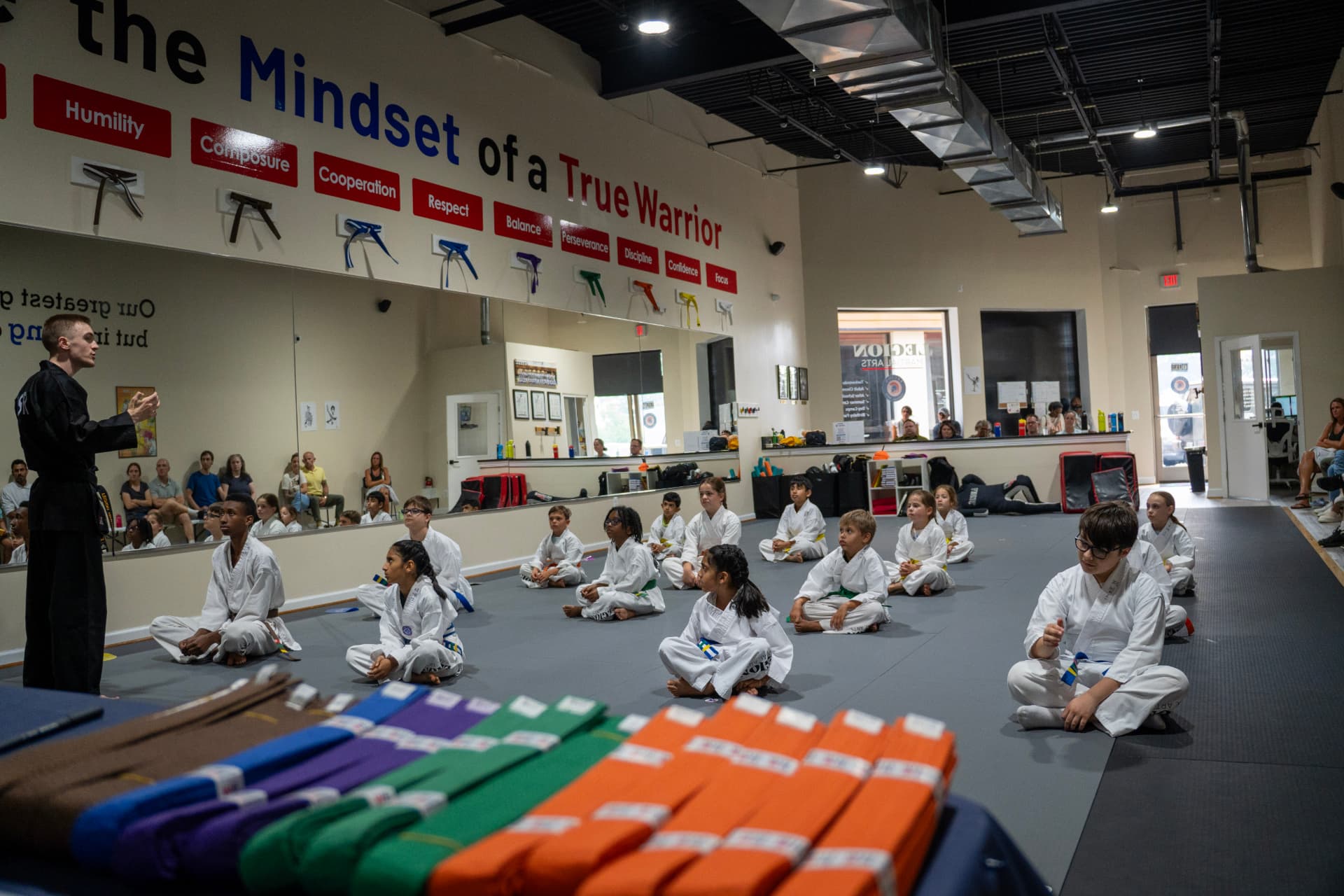 Instructor leading a seated Juniors class in the Gambrills dojang