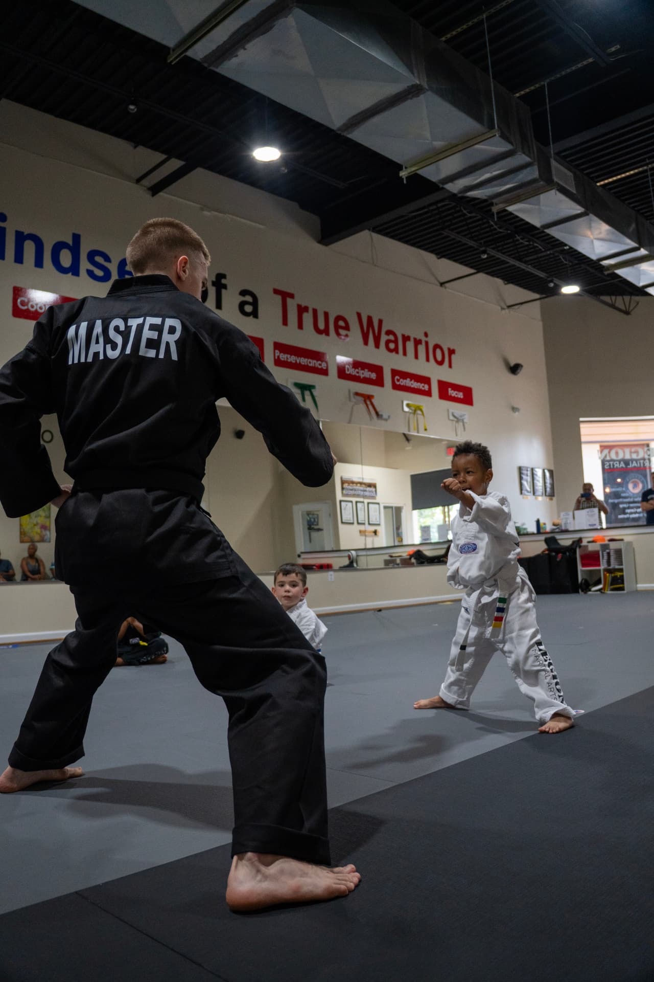 Tiny Tigers student practicing punches with an instructor