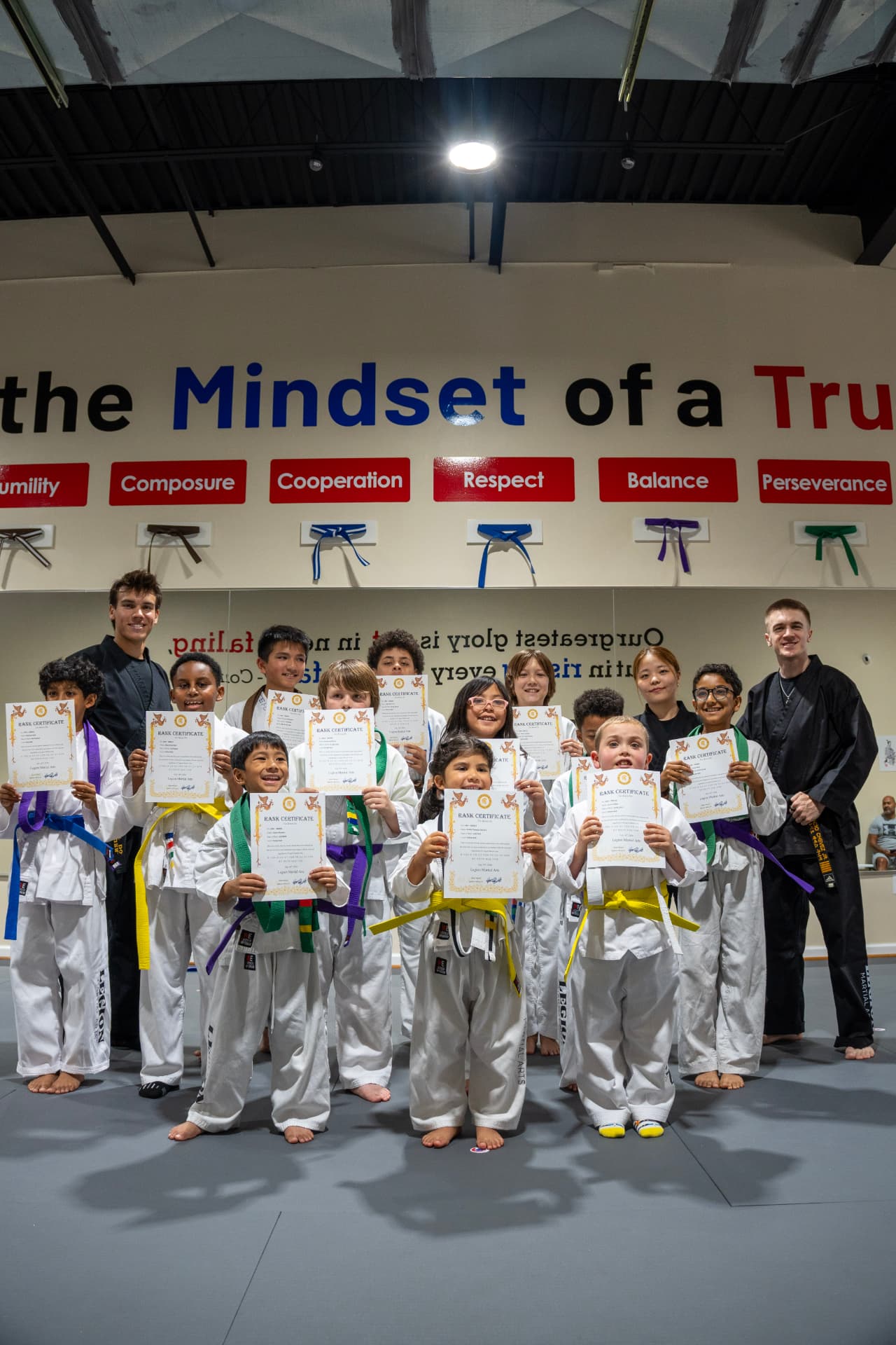 Tiny Tigers students showing their rank certificates