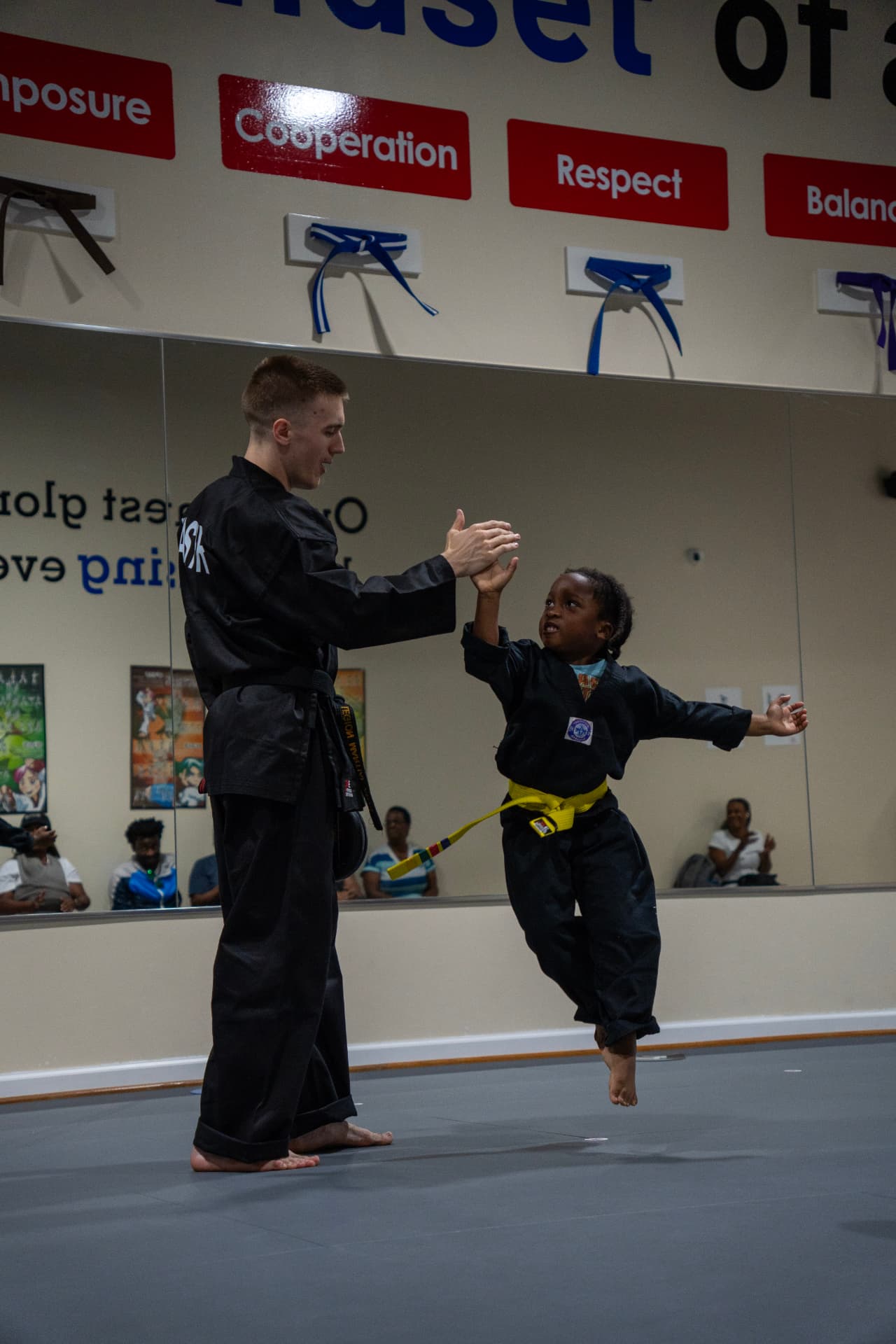 Instructor celebrating with a Tiny Tigers student