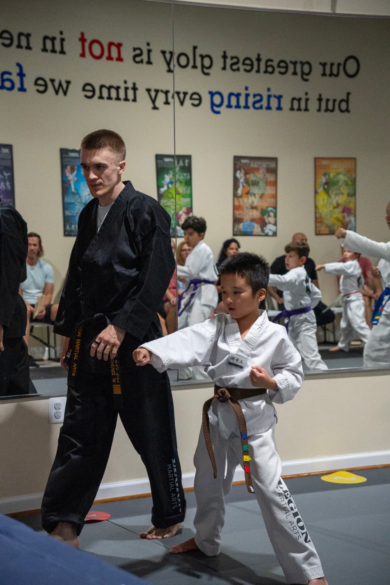 Instructor guiding a Juniors student through a stance