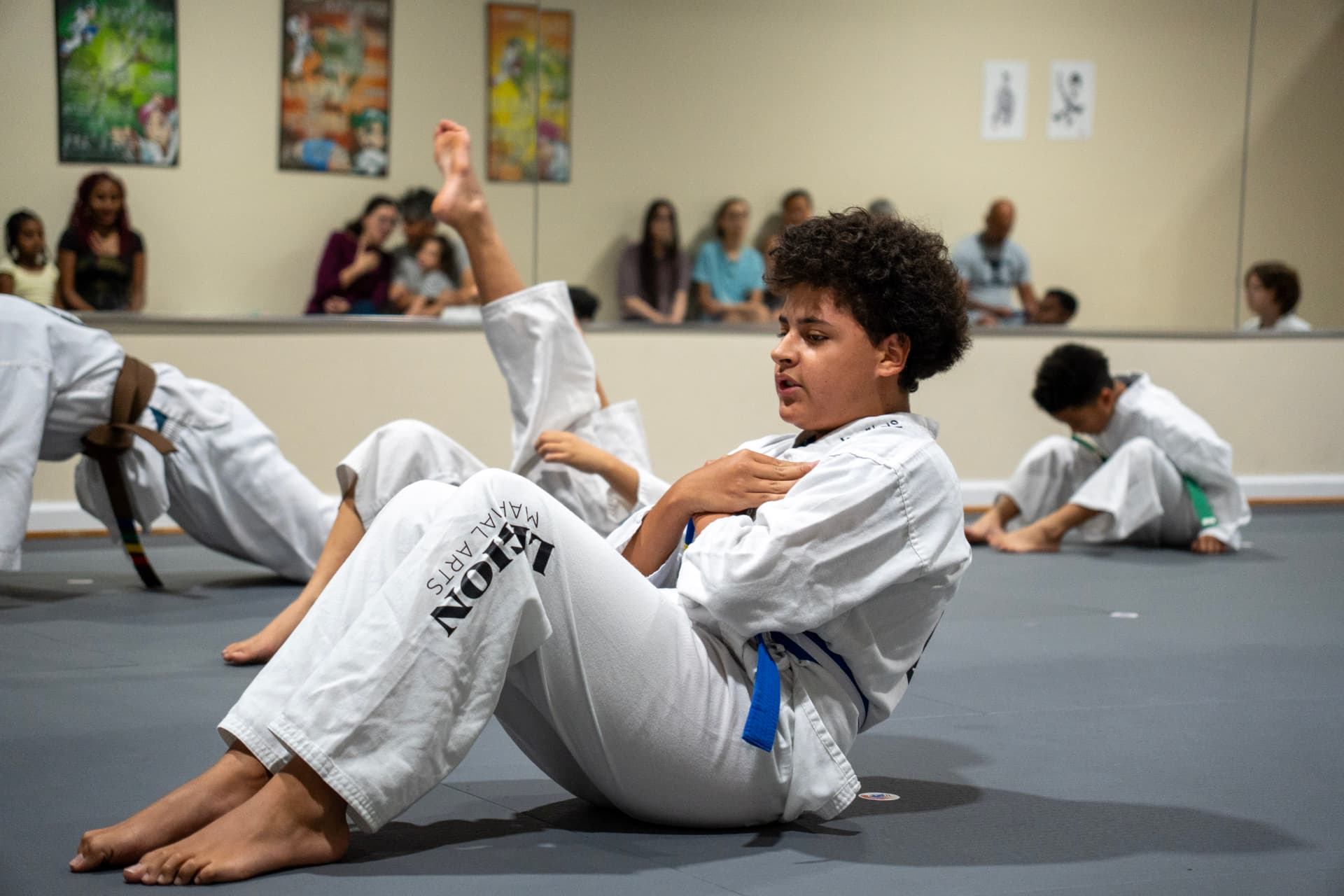 Juniors students stretching and warming up on the mat