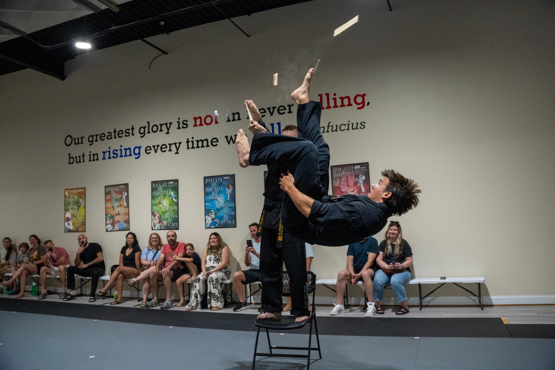 Juniors student breaking a board with a flying kick at Legion Martial Arts
